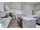 Modern kitchen with white cabinets, stainless steel appliances, and a large island with a sink at 4483 Fell Mist Way, Castle Rock, CO 80109