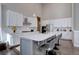 Bright kitchen featuring stainless steel appliances, white cabinets, a large island, and modern lighting fixtures at 4483 Fell Mist Way, Castle Rock, CO 80109