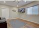 Cozy living room featuring hardwood floors, tv, and a window that brings in natural light at 4483 Fell Mist Way, Castle Rock, CO 80109
