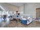 Open-concept living area with hardwood floors, high ceilings, and seamless flow into kitchen and dining areas at 4483 Fell Mist Way, Castle Rock, CO 80109