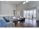 Bright open living area featuring hardwood floors, large windows, and sliding door to covered deck at 4483 Fell Mist Way, Castle Rock, CO 80109
