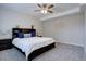 Well-lit main bedroom features a large bed with a dark wood headboard at 4483 Fell Mist Way, Castle Rock, CO 80109