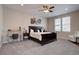 Spacious main bedroom with a dark wood bed frame, a ceiling fan, neutral walls and carpeted floors at 4483 Fell Mist Way, Castle Rock, CO 80109