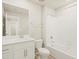 Bathroom featuring a single sink vanity, mirror, toilet, and shower-tub combo at 20982 E 66Th Ave, Aurora, CO 80019