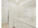 Bright bathroom showcasing a double sink vanity and an expansive mirror at 20982 E 66Th Ave, Aurora, CO 80019