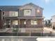 Townhome exterior with brick and siding, porch, and landscaped front at 20982 E 66Th Ave, Aurora, CO 80019