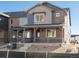 Charming two-story home featuring a brick exterior, covered porch, and well-maintained landscaping at 20982 E 66Th Ave, Aurora, CO 80019