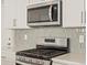 Close-up of the gourmet kitchen featuring stainless steel appliances and a stylish backsplash at 20982 E 66Th Ave, Aurora, CO 80019
