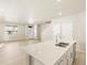 Open concept kitchen features a large island with stainless steel sink at 20982 E 66Th Ave, Aurora, CO 80019