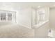 Bright living room featuring neutral carpet, light walls, and ample natural light at 20982 E 66Th Ave, Aurora, CO 80019