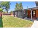 A fenced backyard with a covered patio and well-maintained lawn at 5480 W Iowa Ave, Lakewood, CO 80232
