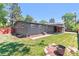 Spacious backyard with a well-manicured lawn, privacy fence, and an inviting patio area at 5480 W Iowa Ave, Lakewood, CO 80232