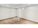 Finished basement with wood-look floors, support beam, and natural light from two windows at 5480 W Iowa Ave, Lakewood, CO 80232