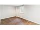 Finished basement featuring a large window and wood-look flooring at 5480 W Iowa Ave, Lakewood, CO 80232