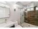 Modern bathroom features a glass-enclosed shower, sleek vanity, and tiled walls at 5480 W Iowa Ave, Lakewood, CO 80232