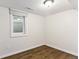 Bedroom featuring a window, wood-look floors, and minimalist design at 5480 W Iowa Ave, Lakewood, CO 80232