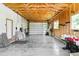 Spacious two car garage featuring exposed beam ceiling and concrete flooring at 5480 W Iowa Ave, Lakewood, CO 80232