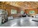 Spacious two car garage featuring exposed beam ceiling and concrete flooring at 5480 W Iowa Ave, Lakewood, CO 80232