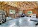 Spacious two car garage featuring exposed beam ceiling and concrete flooring at 5480 W Iowa Ave, Lakewood, CO 80232