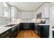 Well-appointed kitchen with stainless steel appliances, a stylish backsplash, and hardwood floors at 5480 W Iowa Ave, Lakewood, CO 80232