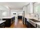 Gourmet kitchen with custom cabinets, stainless steel appliances, and a large island overlooking the open floor plan at 5480 W Iowa Ave, Lakewood, CO 80232