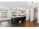 Modern kitchen with a center island, stainless steel appliances, white cabinets, and dark hardwood floors at 5480 W Iowa Ave, Lakewood, CO 80232