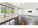 Spacious living room boasting gleaming hardwood floors, large windows, and a modern fireplace at 5480 W Iowa Ave, Lakewood, CO 80232