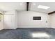 Spacious living room featuring vaulted ceilings, wooden beams, and carpet flooring at 5480 W Iowa Ave, Lakewood, CO 80232