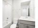 Well-lit bathroom featuring a tub/shower combo, vanity, and modern fixtures at 742 N Tempe St, Aurora, CO 80018
