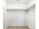 Walk-in closet with neutral carpeting and white shelving for maximum storage and organization at 742 N Tempe St, Aurora, CO 80018