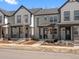 Charming townhouse showcasing stone facade, inviting porch and manicured front yard, perfect for relaxed living at 742 N Tempe St, Aurora, CO 80018