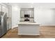 Modern kitchen features sleek stainless steel appliances, center island, and wood floors, creating a stylish cooking space at 742 N Tempe St, Aurora, CO 80018