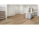 Open-concept living space featuring wood floors, staircase, and a modern kitchen island, perfect for gatherings at 742 N Tempe St, Aurora, CO 80018