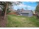 Expansive backyard featuring a well-maintained lawn and a wooden deck, perfect for outdoor activities at 7746 W Quarto Dr, Littleton, CO 80128