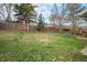 Large grassy backyard with a wooden fence, ideal for recreation and relaxation at 7746 W Quarto Dr, Littleton, CO 80128