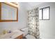 Bright bathroom featuring a vanity, toilet, tub and shower combination, and a decorative, colorful shower curtain at 7746 W Quarto Dr, Littleton, CO 80128