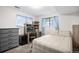 Comfortable bedroom with a workstation, neutral colored walls and natural light to the space at 7746 W Quarto Dr, Littleton, CO 80128