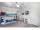 Bright bedroom with bunk beds, carpet flooring, and ample closet space at 7746 W Quarto Dr, Littleton, CO 80128