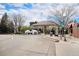 Elegant commercial building on a tree-lined street, offering a mix of retail and dining establishments at 7746 W Quarto Dr, Littleton, CO 80128