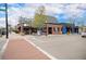 Charming commercial building with a brick facade, featuring various storefronts and street parking at 7746 W Quarto Dr, Littleton, CO 80128