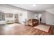 Open living room with wood-look floors, a comfortable sofa, toy storage and a cozy atmosphere at 7746 W Quarto Dr, Littleton, CO 80128