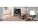 Open living room with a view to the kitchen, hardwood floors, carpet, and natural light at 7746 W Quarto Dr, Littleton, CO 80128