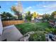 Spacious backyard with a well-maintained lawn, patio, rock-rimmed pond, and a new wooden fence at 3216 S Granby Way, Aurora, CO 80014