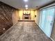 Basement featuring stylish wood paneling and a brick fireplace at 3216 S Granby Way, Aurora, CO 80014