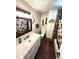 Bathroom featuring stylish wood-look flooring, tiled shower and a vanity at 3216 S Granby Way, Aurora, CO 80014