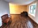 Cozy living room featuring stylish wood-look flooring and a comfortable seating area at 3216 S Granby Way, Aurora, CO 80014