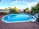 Backyard featuring an above-ground pool, wood deck, and surrounding residential neighborhood at 3216 S Granby Way, Aurora, CO 80014