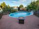 Above-ground pool and deck with a gas fire pit, set in a backyard with a wooden fence at 3216 S Granby Way, Aurora, CO 80014