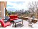 Relaxing outdoor patio area with comfortable seating, a stone wall, and views of the backyard and nearby playground at 1902 Pioneer Cir, Lafayette, CO 80026