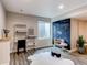 Finished basement area with gray wood flooring and chalkboard accent wall with natural light at 1902 Pioneer Cir, Lafayette, CO 80026